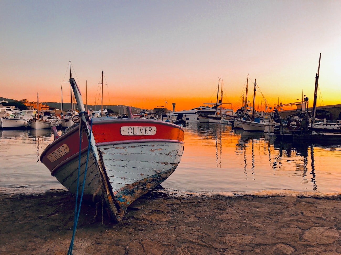 Wooden workboat moored in a small harbor at golden hour